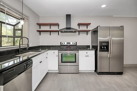 a kitchen with stainless steel appliances and white cabinets