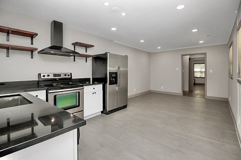 a kitchen with white cabinets and stainless steel appliances