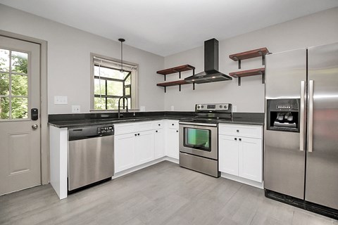 a kitchen with stainless steel appliances and white cabinets