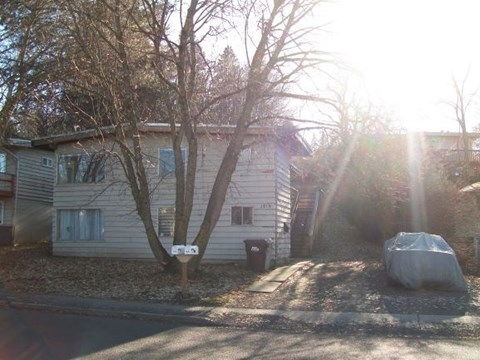 A house with a car parked in front of it.
