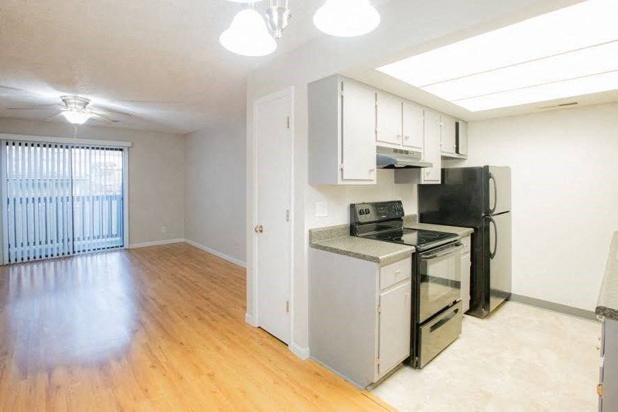 A kitchen area with a stove, oven, and refrigerator.