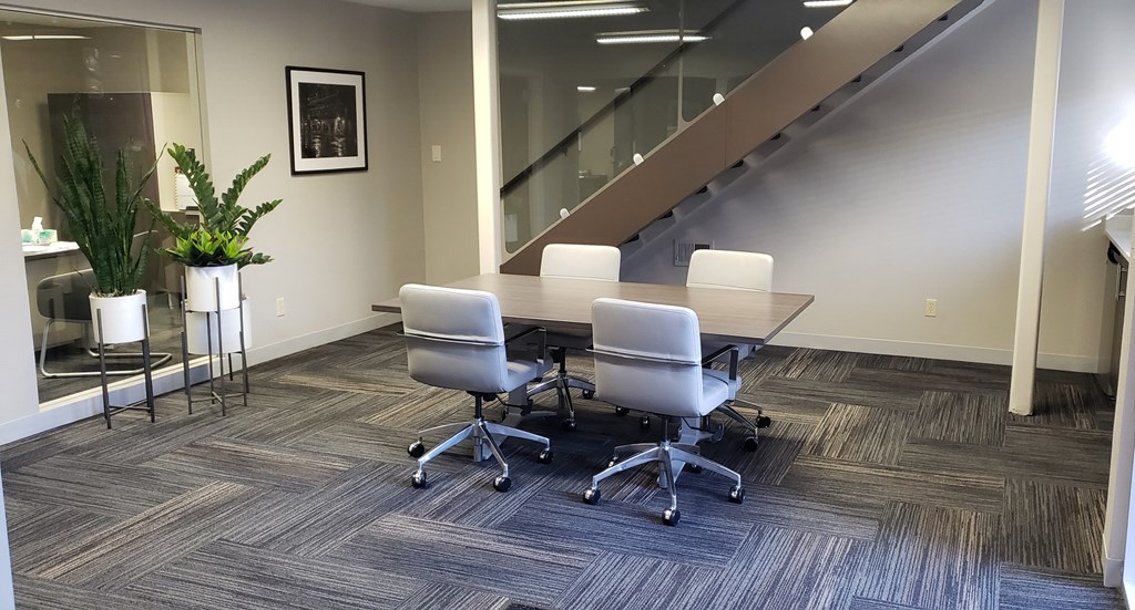 a conference room with a large table and chairs