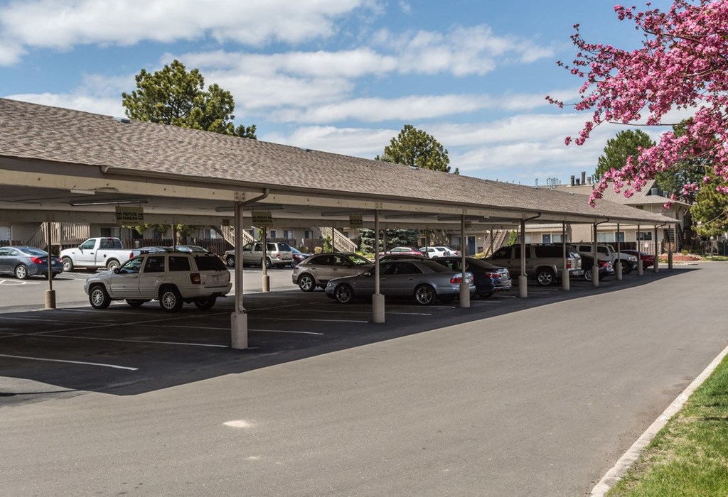 a parking lot with cars in front of a building