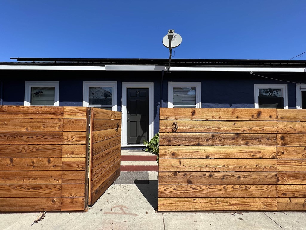 a wooden fence in front of a house