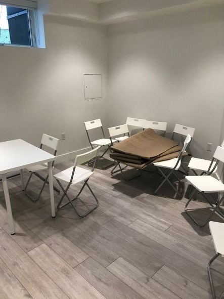 A room with a table and chairs.