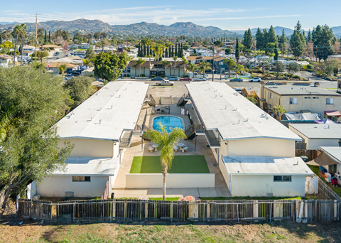 A large white building with a pool in the middle of it.