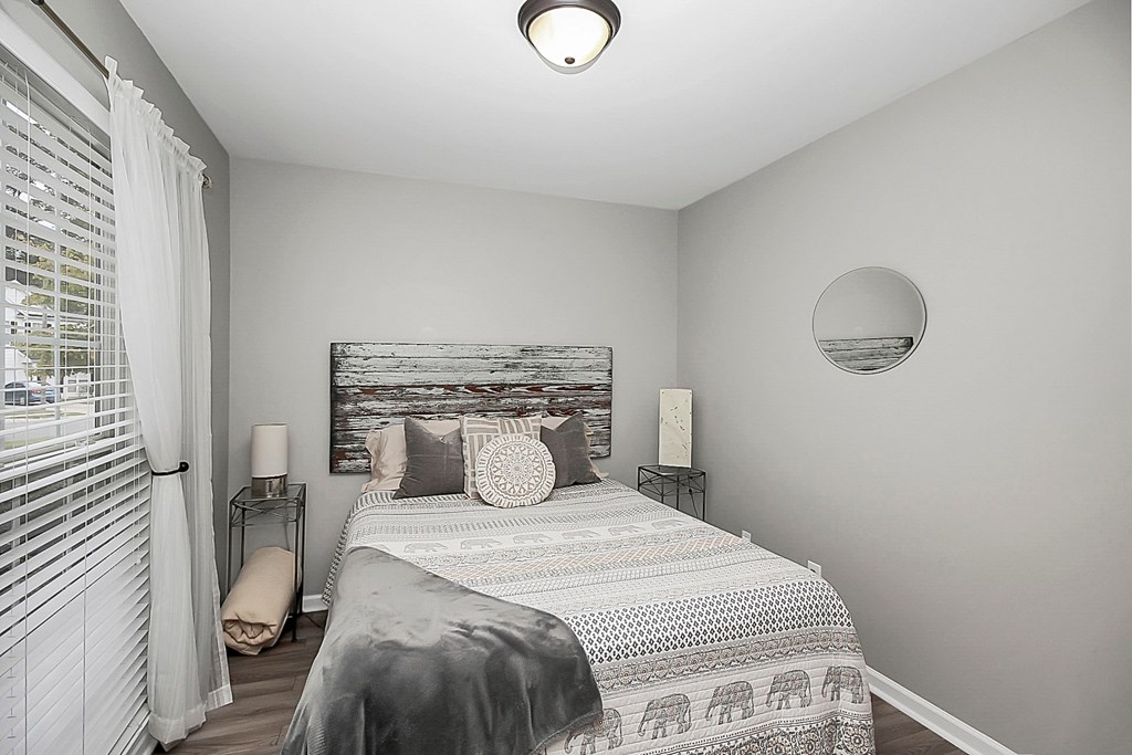 a bedroom with a bed and a window