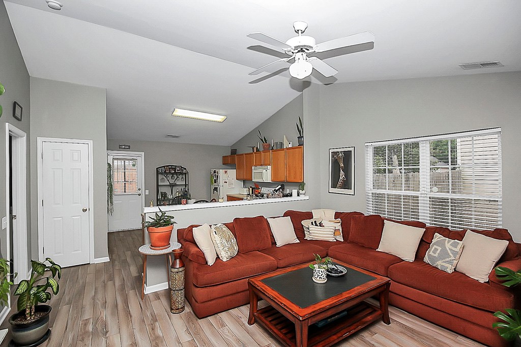 a living room with a couch and a ceiling fan
