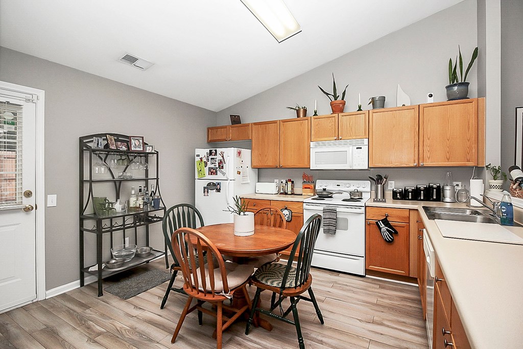 a kitchen and dining room with a table and chairs