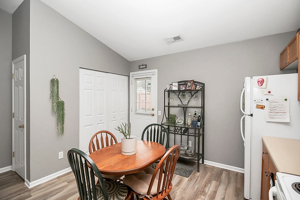 a kitchen and dining room with a wooden table and chairs