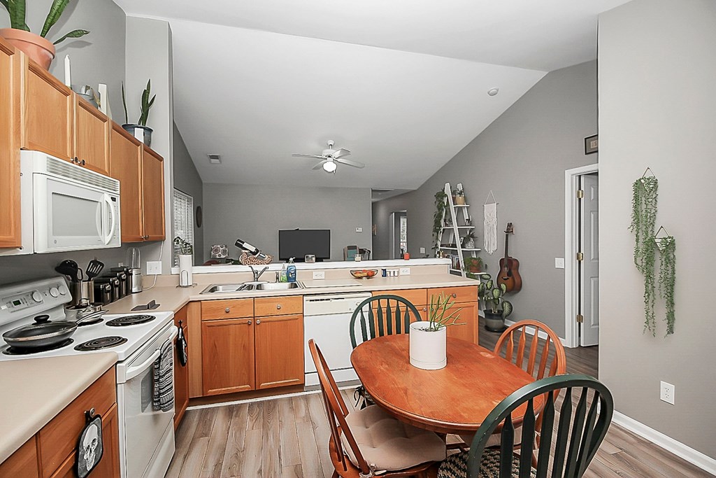 a kitchen and dining area with a wooden table and chairs
