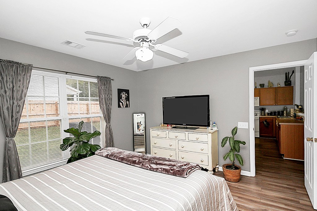 a bedroom with a bed and a ceiling fan