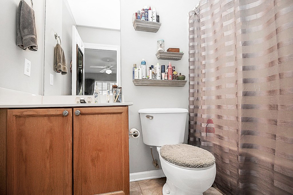 a bathroom with a shower and a toilet and a sink