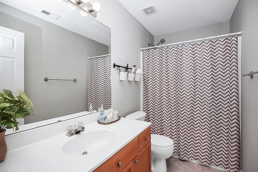 a bathroom with a white sink and a shower and a toilet