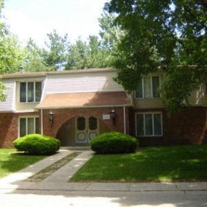 A house with a brown roof and a white door.