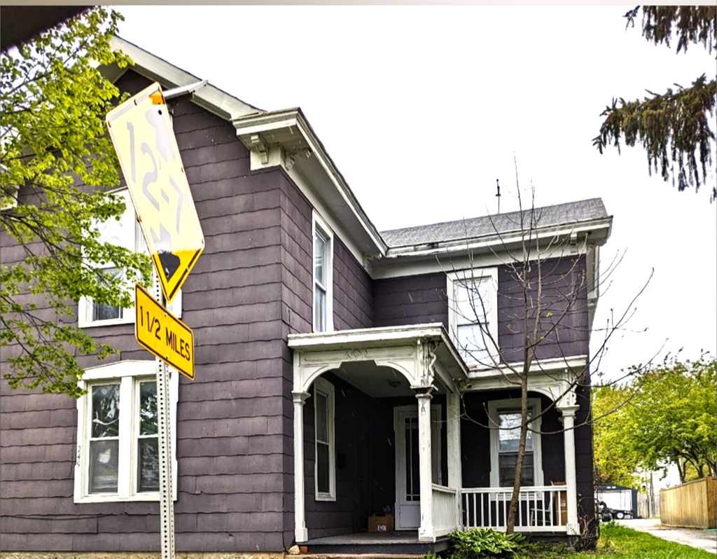 a house with a street sign in front of it