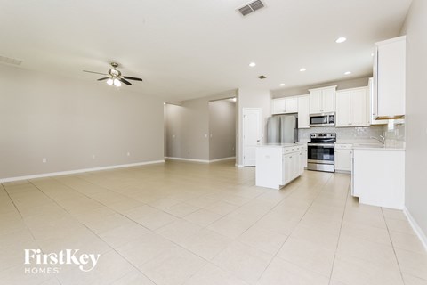 A spacious kitchen with white cabinets and appliances.