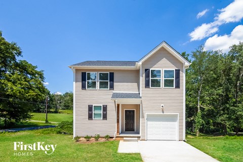 a tan house with a white garage door