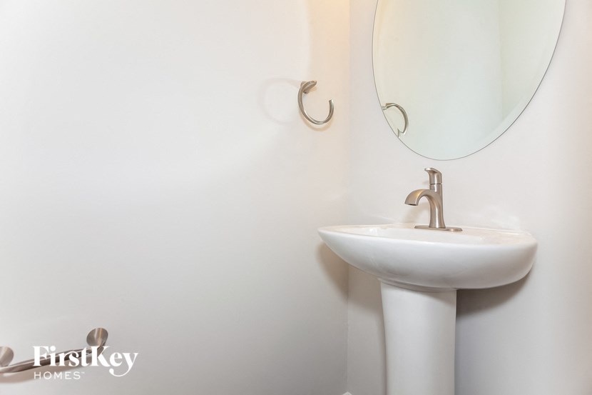 a white bathroom with a sink and a mirror