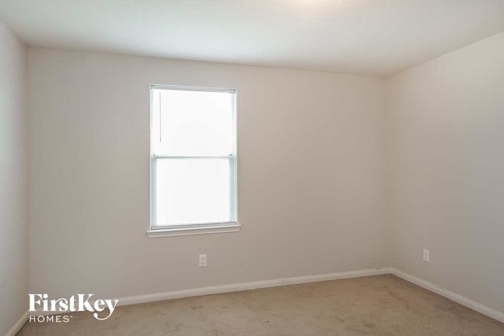A room with a window and a FirstKey Homes logo.
