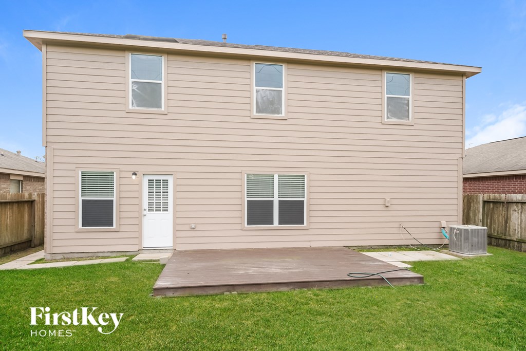 A house with a white door and windows is for sale.