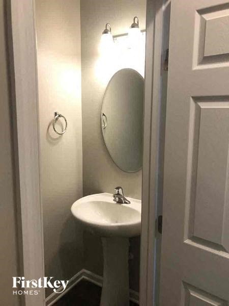 a bathroom with a white sink and a mirror