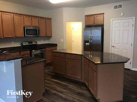 a kitchen with a counter top and a refrigerator