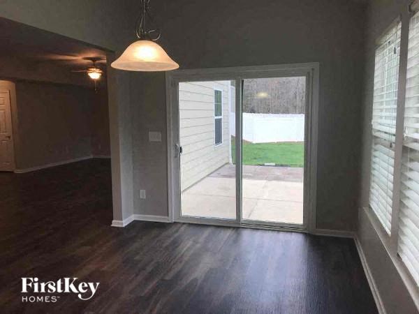 an empty living room with a sliding glass door