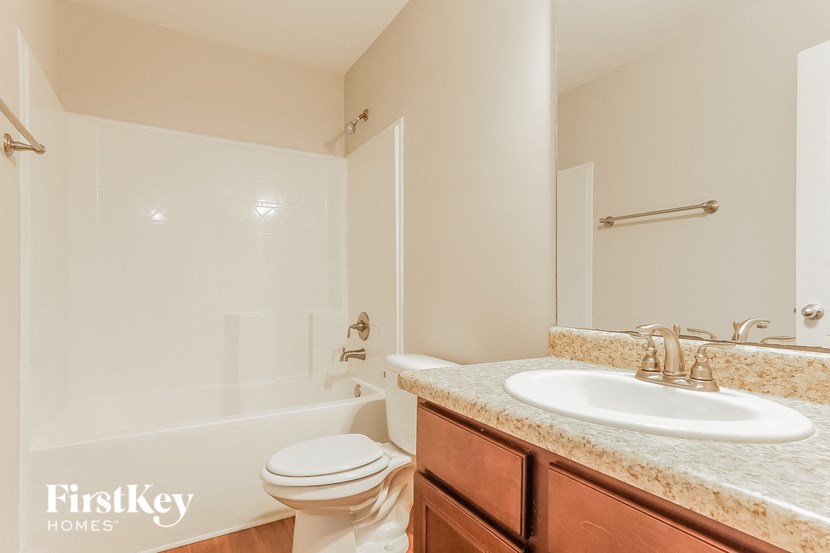 a bathroom with a sink toilet and a bath tub