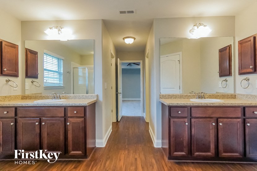 a bathroom with two sinks and a large mirror