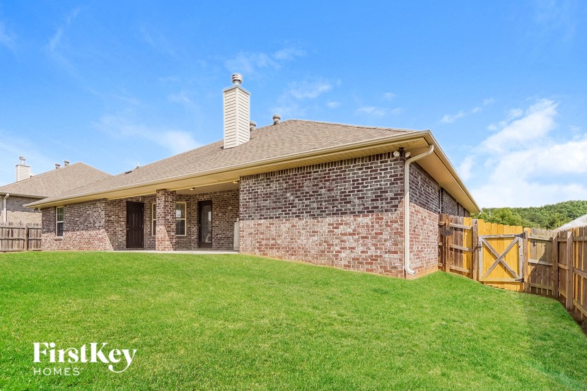 a brick house with a yard and a wooden fence