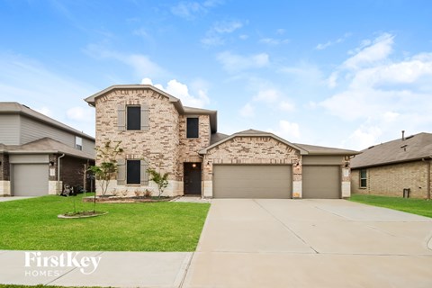 A large house with a stone facade and a garage door.