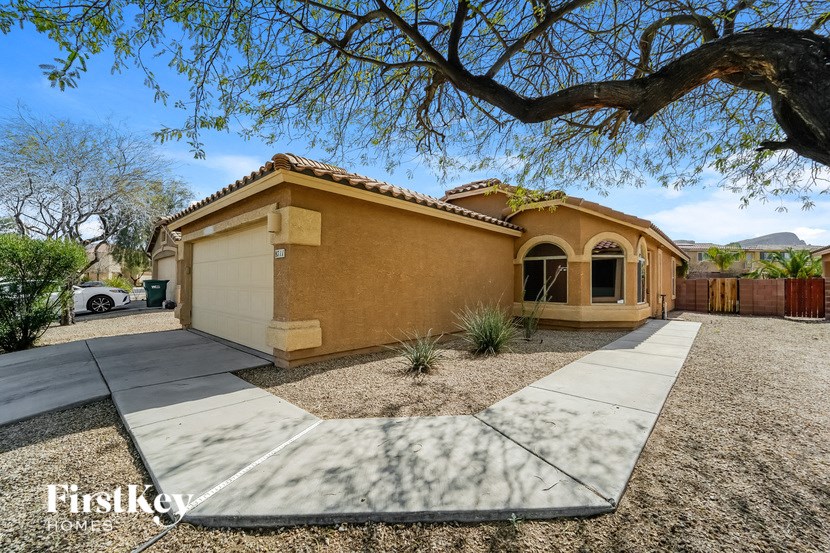 a house with a sidewalk and a tree