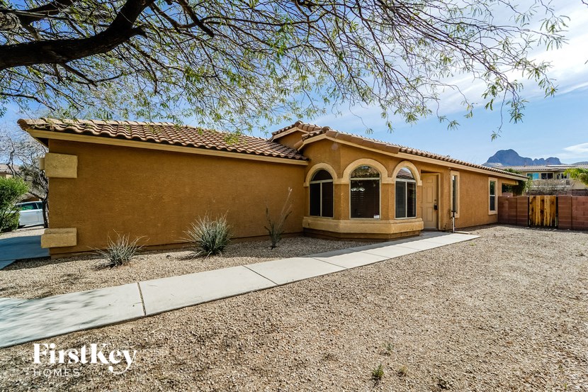 a house with a driveway and a tree