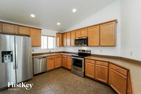 a kitchen with wooden cabinets and stainless steel appliances