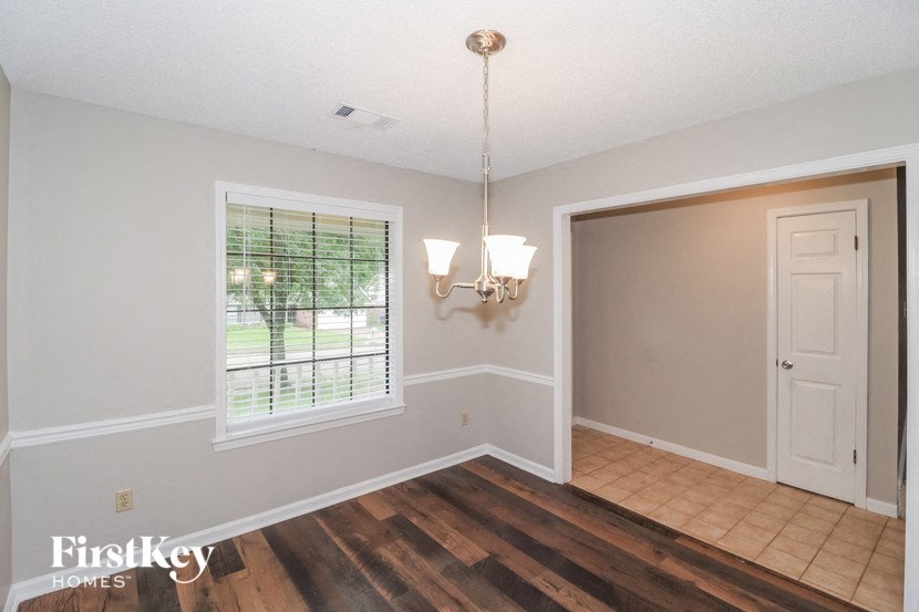 an empty living room with a window and a door