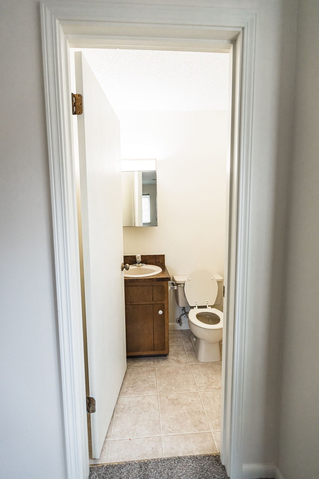 A white bathroom with a toilet and sink.