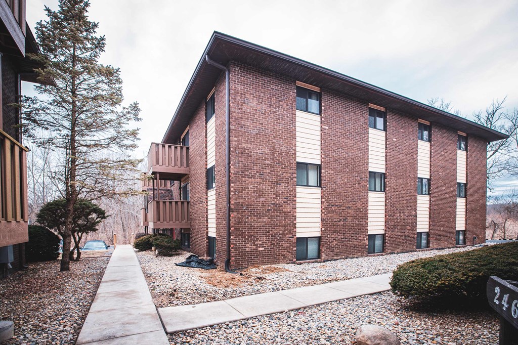 A brick building with a white trim around the windows.