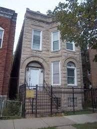 A brick building with a white door and windows.