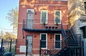 a red building with a balcony and a door