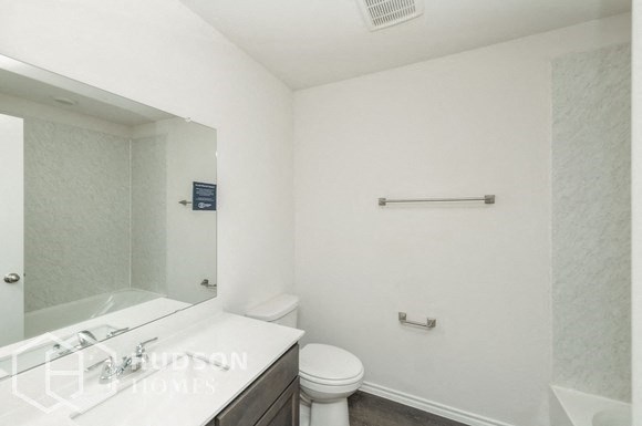 a bathroom with a sink toilet and a mirror