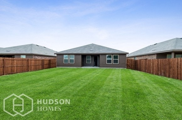 a backyard with a lawn and a house