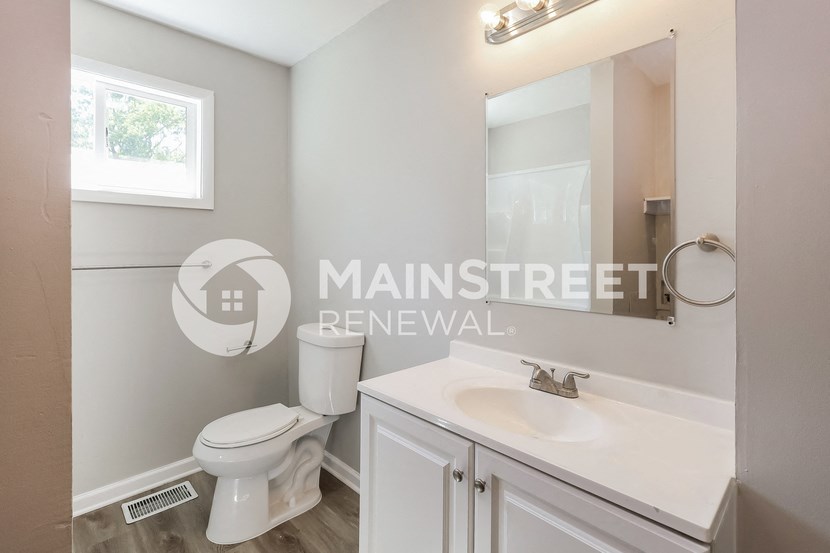 a bathroom with a sink and a toilet and a mirror