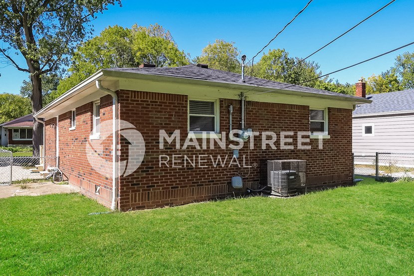 a small brick house with the words main street renewal on the side