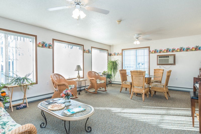 a living room with a dining room table and chairs