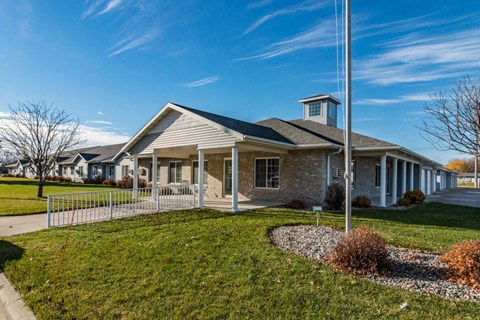 a building with a lawn and a flagpole in front of it