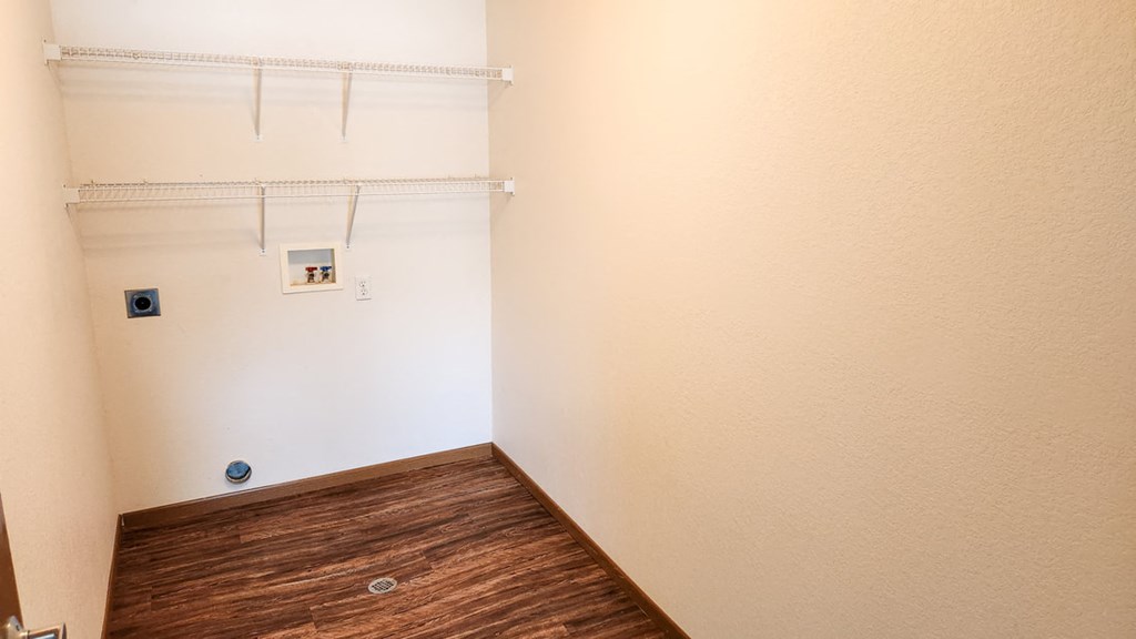 a empty room with a closet and a wood floor