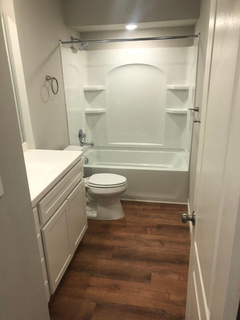 a small bathroom with a toilet and a bath tub