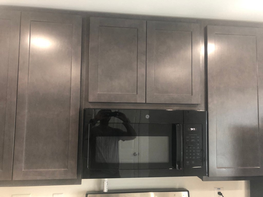 a kitchen with stainless steel cabinets and a microwave