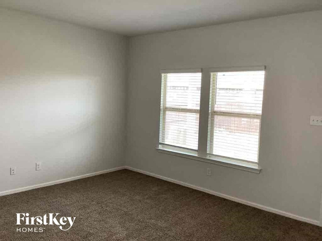 an empty room with two windows in it